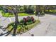 View of the neighborhood entrance sign, surrounded by colorful flower beds and lush greenery at 1 Tomoka Oaks Blvd # 112, Ormond Beach, FL 32174