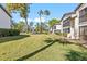 A manicured community green-space featuring shady trees and well-maintained condominium buildings at 1 Tomoka Oaks Blvd # 112, Ormond Beach, FL 32174