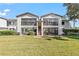 Exterior of a well-maintained building with large windows, balconies, and green lawns at 1 Tomoka Oaks Blvd # 112, Ormond Beach, FL 32174