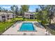 View of the community pool surrounded by well-manicured lawns, patio furniture, and lounging chairs at 1 Tomoka Oaks Blvd # 112, Ormond Beach, FL 32174