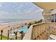 Enjoy ocean, pool, and beach views from this cozy balcony with comfortable seating at 1133 Ocean Shore Blvd # 302, Ormond Beach, FL 32176