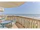 Scenic balcony view of the ocean with a table and chairs to enjoy the view at 1133 Ocean Shore Blvd # 302, Ormond Beach, FL 32176