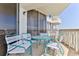 Cozy balcony with seating offers partial views of the ocean and nearby beachside amenities at 1133 Ocean Shore Blvd # 302, Ormond Beach, FL 32176