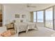 Bright bedroom with two beds, ceiling fan, neutral carpet, ocean view, and access to a balcony at 1133 Ocean Shore Blvd # 302, Ormond Beach, FL 32176