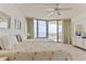 Bright bedroom with floor-to-ceiling windows leading to a balcony with ocean views at 1133 Ocean Shore Blvd # 302, Ormond Beach, FL 32176