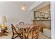 Dining area featuring a wooden table with seating, a lamp and a peek into the kitchen at 1133 Ocean Shore Blvd # 302, Ormond Beach, FL 32176