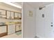 Kitchen area featuring a white appliance suite and an adjacent entrance at 1133 Ocean Shore Blvd # 302, Ormond Beach, FL 32176