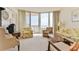 Living room boasts an ocean view, floral sofa, and comfortable seating, creating a relaxing space at 1133 Ocean Shore Blvd # 302, Ormond Beach, FL 32176