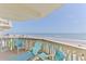 Condo balcony with chairs overlooking the beach and ocean at 1133 Ocean Shore Blvd # 303, Ormond Beach, FL 32176