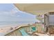 Balcony with beach view and blue outdoor chairs at 1133 Ocean Shore Blvd # 303, Ormond Beach, FL 32176