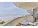 A cozy balcony featuring a table and chairs with an ocean view at 1133 Ocean Shore Blvd # 303, Ormond Beach, FL 32176