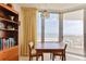 Bright dining area with ocean views, featuring a wooden table and access to the balcony at 1133 Ocean Shore Blvd # 303, Ormond Beach, FL 32176