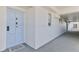 Hallway view of unit 303, showing the entrance door with a light blue finish and neutral carpet at 1133 Ocean Shore Blvd # 303, Ormond Beach, FL 32176