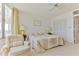 Cozy main bedroom featuring neutral carpet, light walls, and view of the balcony at 1133 Ocean Shore Blvd # 303, Ormond Beach, FL 32176