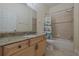 Well lit bathroom features granite countertops and a shower-tub combo at 1425 Ocean Shore Blvd # 102, Ormond Beach, FL 32176