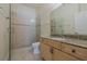 Bathroom features a glass-enclosed shower and granite countertops at 1425 Ocean Shore Blvd # 102, Ormond Beach, FL 32176