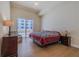 Bedroom featuring wood floors and balcony access at 1425 Ocean Shore Blvd # 102, Ormond Beach, FL 32176