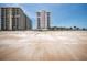 Ocean view of condo building on a sunny day, taken from beach at 1425 Ocean Shore Blvd # 102, Ormond Beach, FL 32176