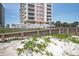 Building exterior as seen from the beach, showing dune vegetation at 1425 Ocean Shore Blvd # 102, Ormond Beach, FL 32176