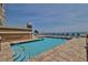 Outdoor pool area featuring clear blue water and comfortable lounge chairs at 1425 Ocean Shore Blvd # 102, Ormond Beach, FL 32176