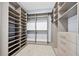 A spacious walk-in closet features custom built-in shelving, drawers, and carpet, creating a luxurious dressing area at 2244 S Halifax Dr, Daytona Beach, FL 32118