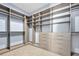 A large walk-in closet provides ample storage with built-in shelves, drawers, and hanging rods for an organized wardrobe at 2244 S Halifax Dr, Daytona Beach, FL 32118