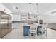 Open kitchen featuring blue island, stainless steel appliances, and white cabinets with stone countertops at 2244 S Halifax Dr, Daytona Beach, FL 32118