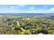 Lush, green aerial shot highlighting the property within a landscape of trees and a distant lake at 2337 Legacy Ln, New Smyrna Beach, FL 32168