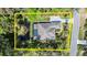 Aerial view showcasing the property's layout, including a pool, pond, and proximity to the street at 2337 Legacy Ln, New Smyrna Beach, FL 32168