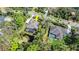 Aerial view of two houses showing screened pool areas, pond, and tree-lined surroundings at 2337 Legacy Ln, New Smyrna Beach, FL 32168