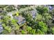 Aerial view of the property featuring a screened pool area, pond, and tree-lined surroundings at 2337 Legacy Ln, New Smyrna Beach, FL 32168