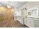 Elegant primary bathroom with double sinks, granite countertops, a shower and chandelier at 2337 Legacy Ln, New Smyrna Beach, FL 32168