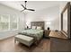 Well-lit bedroom featuring a comfortable bed, classic wooden furniture, and natural light from the window at 2337 Legacy Ln, New Smyrna Beach, FL 32168