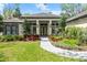 Beautiful single-story home featuring a well-manicured lawn and inviting front entrance with landscaped garden beds at 2337 Legacy Ln, New Smyrna Beach, FL 32168