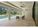 Beautiful travertine pool deck with seating area and ceiling fans for comfortable outdoor living at 2337 Legacy Ln, New Smyrna Beach, FL 32168