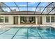 Sparkling pool area with outdoor seating and a screened-in enclosure at 2337 Legacy Ln, New Smyrna Beach, FL 32168