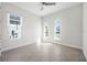 Bright bedroom featuring two windows, a ceiling fan, and tile flooring at 525 Mosaic Blvd, Daytona Beach, FL 32124