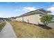 Well-maintained home exterior with lush landscaping, a side-entry garage, and manicured lawn at 525 Mosaic Blvd, Daytona Beach, FL 32124