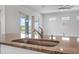 Close-up of a sink in the kitchen with granite countertops and a view to the backyard at 525 Mosaic Blvd, Daytona Beach, FL 32124