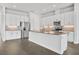 A modern kitchen featuring white cabinetry, stainless appliances, and tile flooring at 525 Mosaic Blvd, Daytona Beach, FL 32124