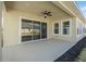 Covered patio features a ceiling fan and sliding glass doors for seamless indoor-outdoor living at 525 Mosaic Blvd, Daytona Beach, FL 32124