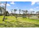 A well-kept community park features picnic tables, BBQ pit, green space and beautiful water view at 57 Bella Lago Cir, Port Orange, FL 32129