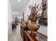 Hallway with elegant decor, featuring a decorative mirror, table, vase, and tile flooring at 57 Bella Lago Cir, Port Orange, FL 32129