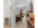 Hallway view of a dining area and living space with tile flooring, elegant decor, and natural light at 57 Bella Lago Cir, Port Orange, FL 32129