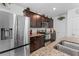 Modern kitchen with stainless steel appliances, granite countertops, dark cabinets, and tile flooring at 57 Bella Lago Cir, Port Orange, FL 32129