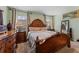 The main bedroom has a bed, 2 side tables, 2 windows, and a mirror at 57 Bella Lago Cir, Port Orange, FL 32129