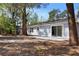 The backyard features a patio area and mature trees creating a private oasis at 1011 Indian Oaks W, Daytona Beach, FL 32117