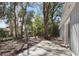 The backyard features a patio area that leads into the fully treed area of the property at 1011 Indian Oaks W, Daytona Beach, FL 32117