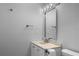 Light-filled bathroom with modern vanity, sink, faucet, and updated mirror at 1011 Indian Oaks W, Daytona Beach, FL 32117