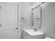 Bright bathroom with modern mirror, vanity with white sink and fixtures, and a door at 1011 Indian Oaks W, Daytona Beach, FL 32117